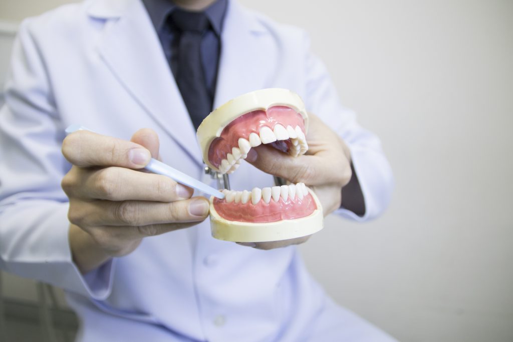 dentist recommending crooked teeth treatment